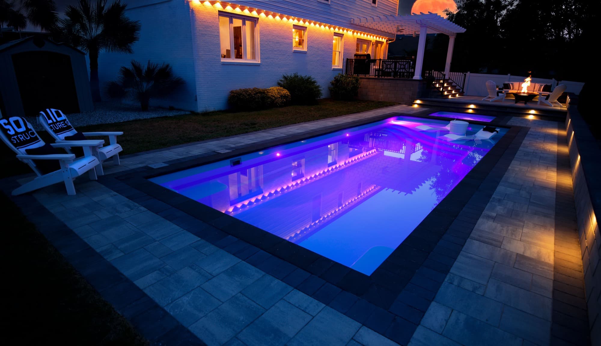 Solid Structures pool lit up at night